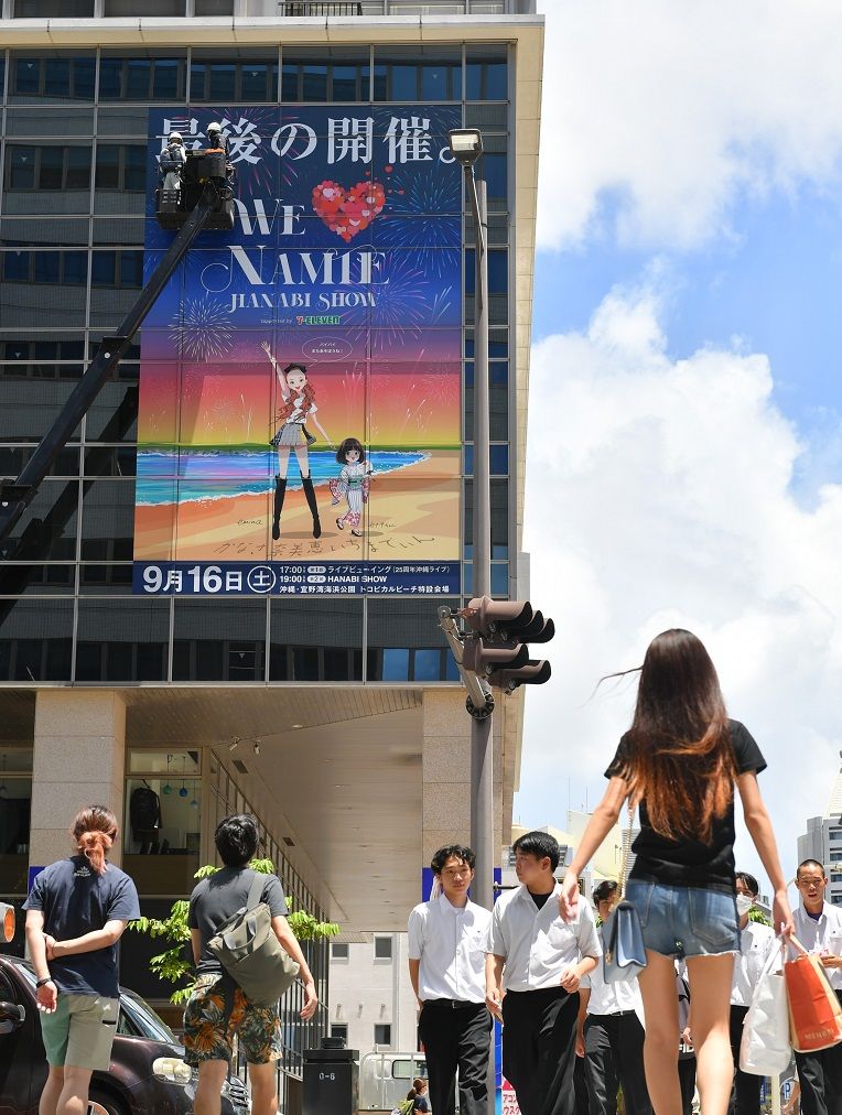 安室奈美恵さんを冠した最後の花火ショーの特大広告が、国道58号沿いのタイムスビル壁面に登場した＝11日午後、那覇市久茂地（名護大輝撮影）