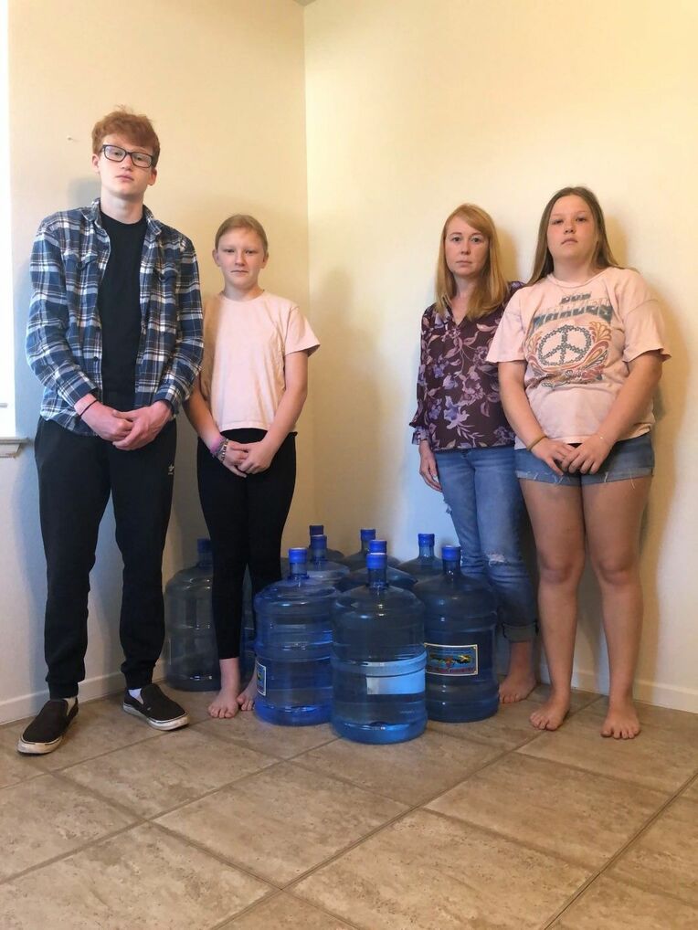 <div class="caption">Amanda Zawieruszynski, (second from right) and her three children have all been poisoned by the US Navy’s fuel contamination of their home’s drinking water. (Jon Mitchell)</div>